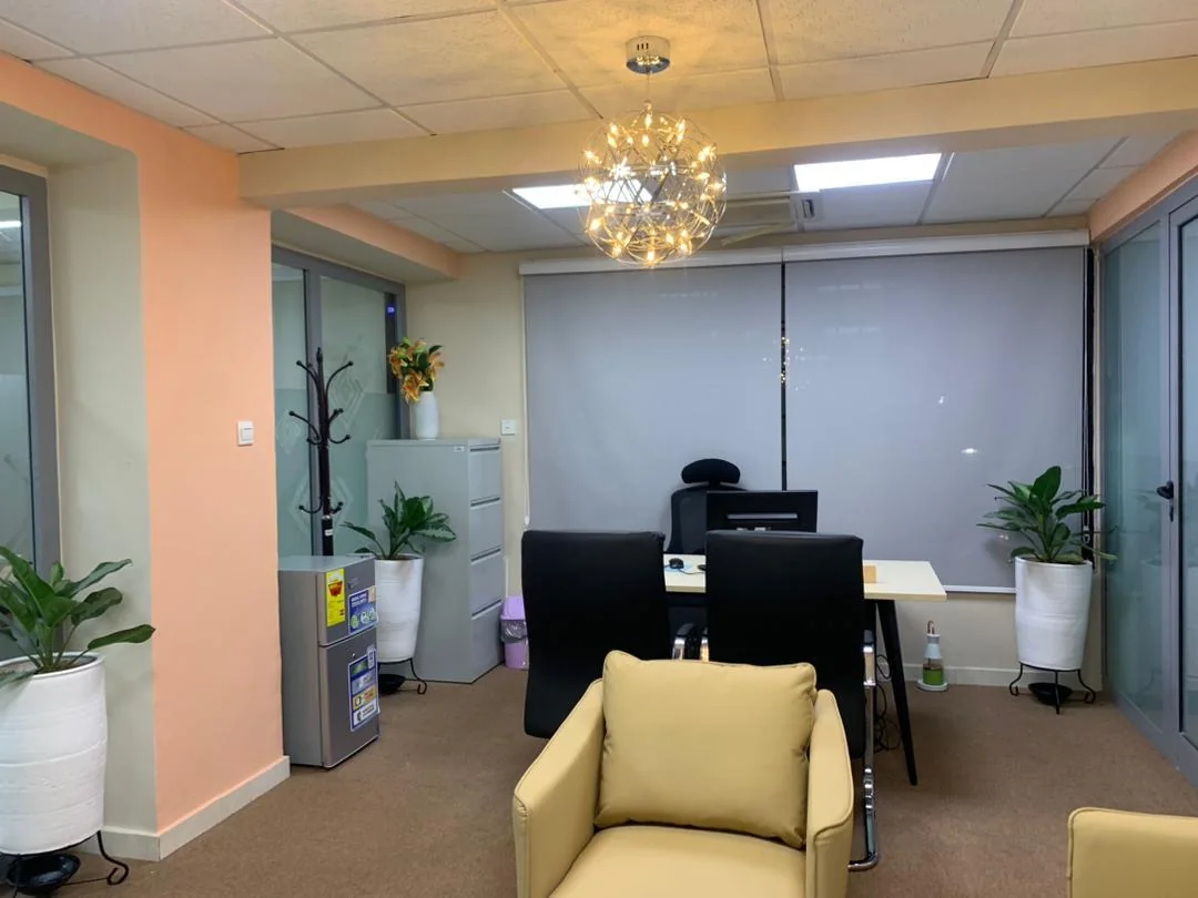 Private office suite with a statement chandelier and soft palette